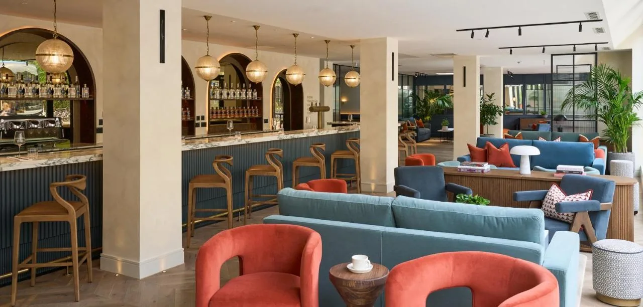 Restaurant bar with blue and orange chairs at The Store hotel in Oxford