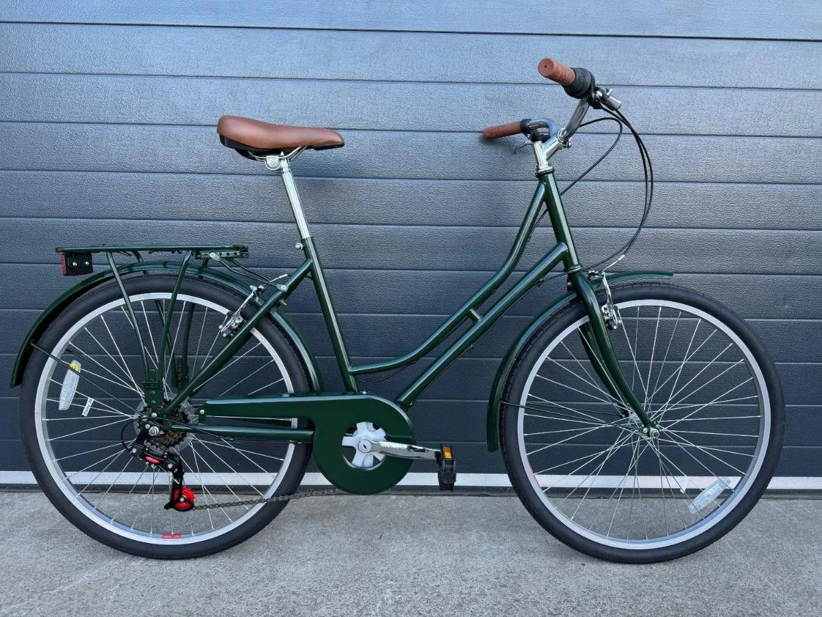 Green hire bike parked outside The Store hotel in Oxford city centre