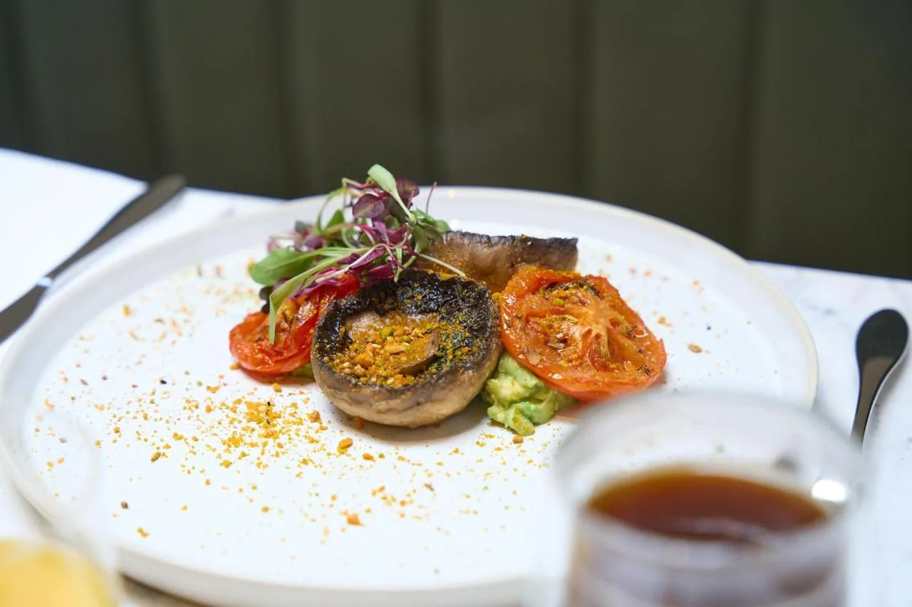 Plated dish with tomatoes and meat served at The Store's restaurant
