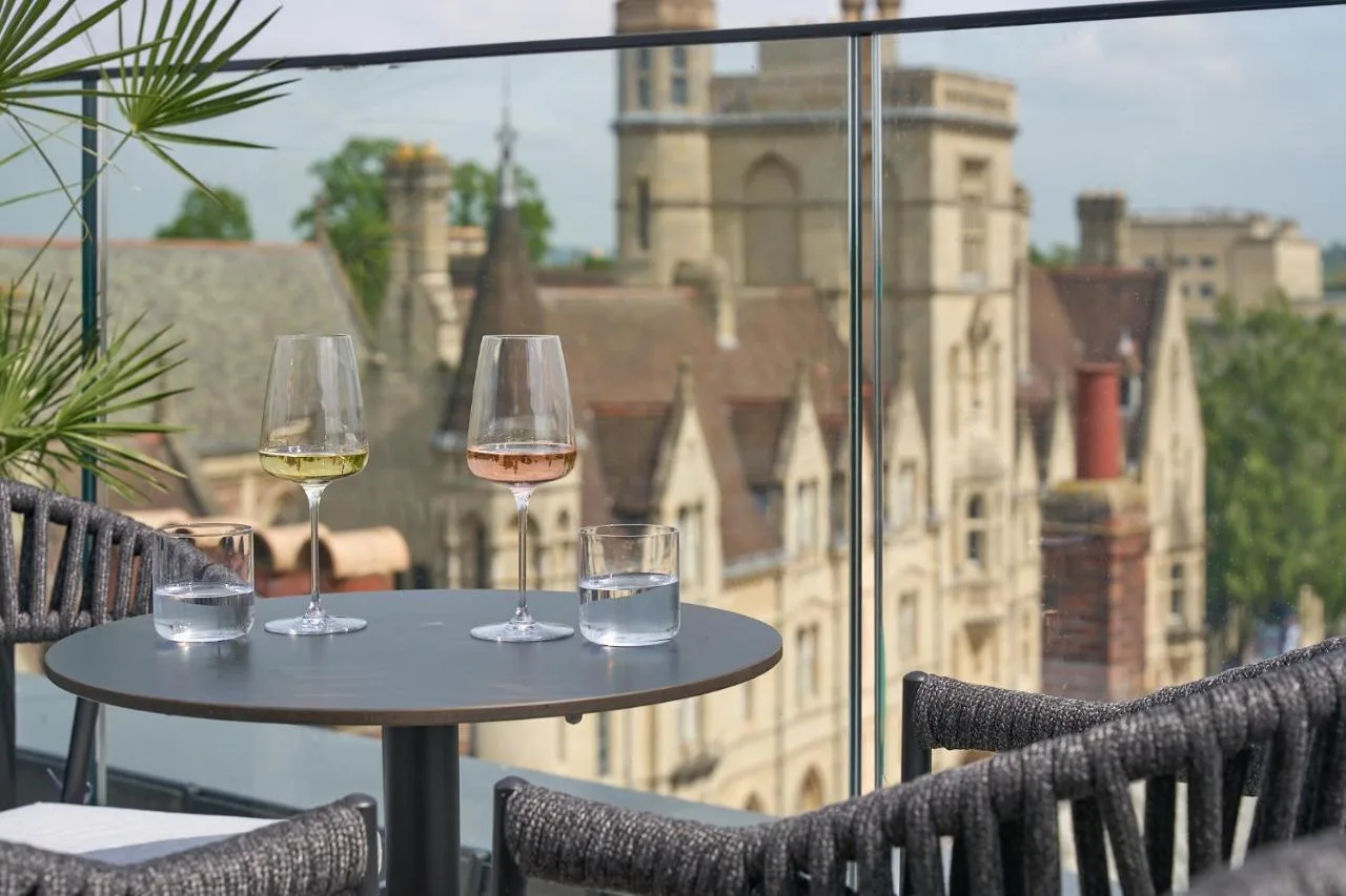 Three wine glasses set on a balcony table at The Store hotel